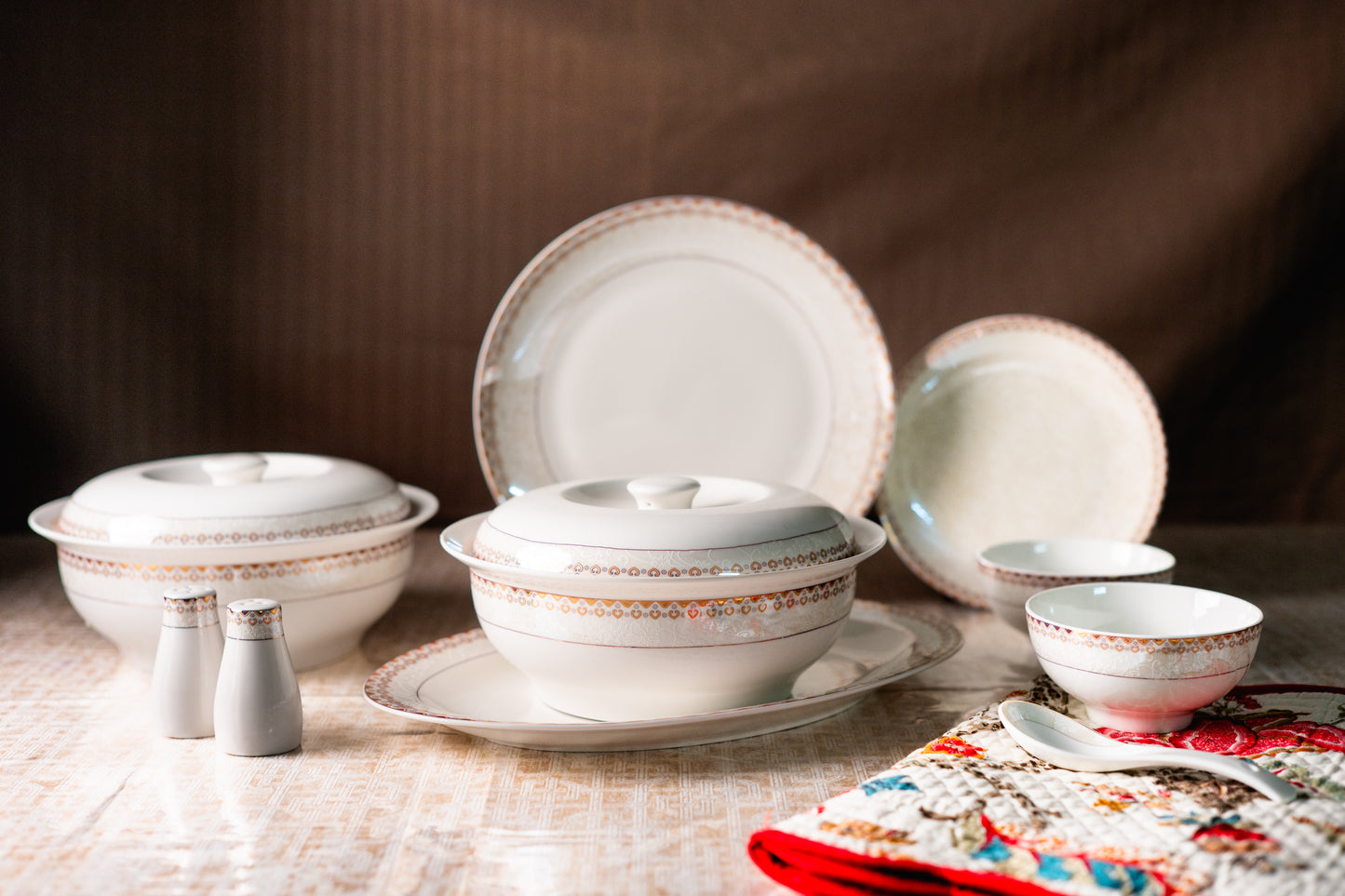 Dishware set with ceramic bowls and plates on a wooden surface.