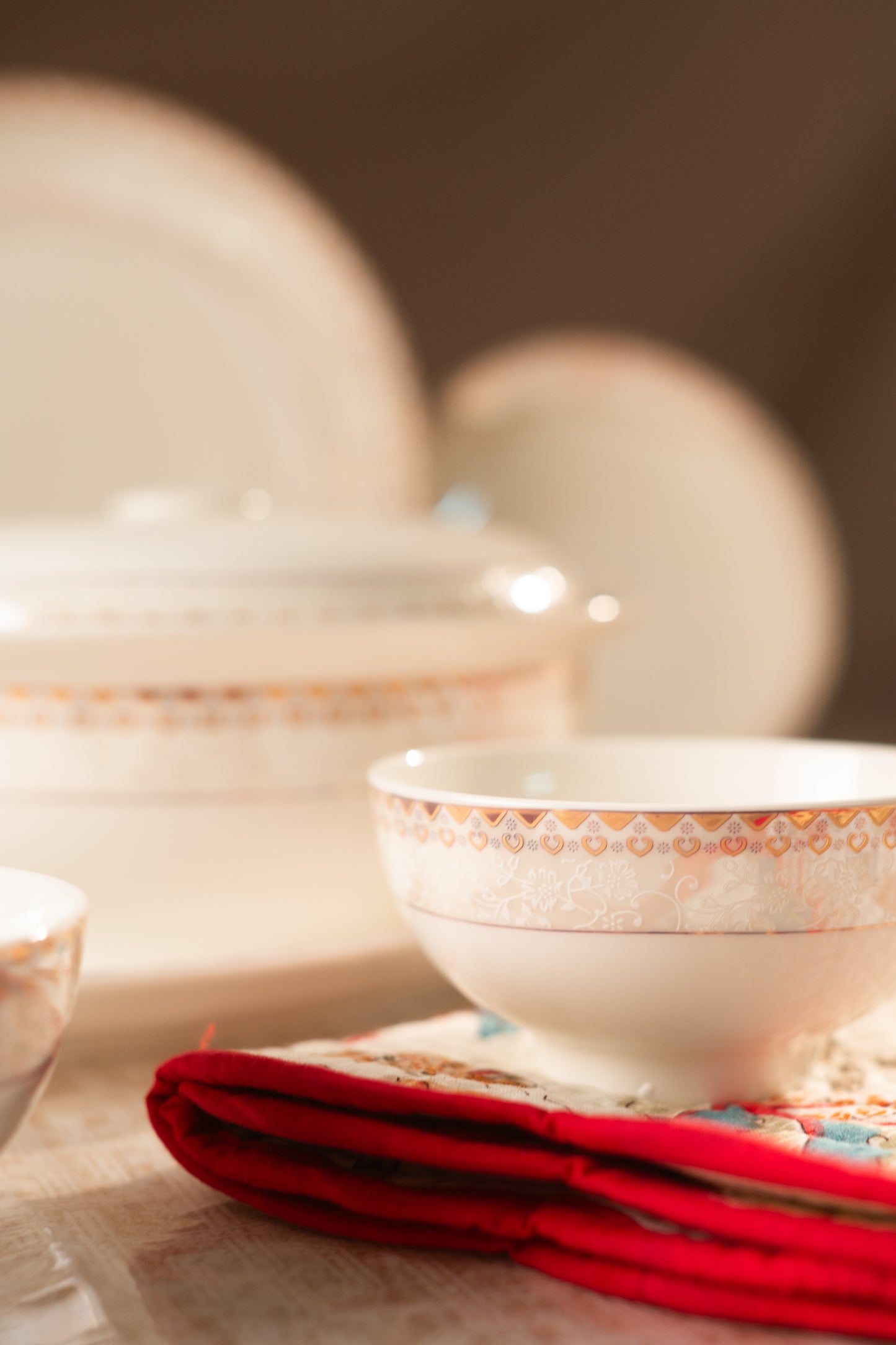 Ceramic bowls with decorative patterns on a tablecloth.