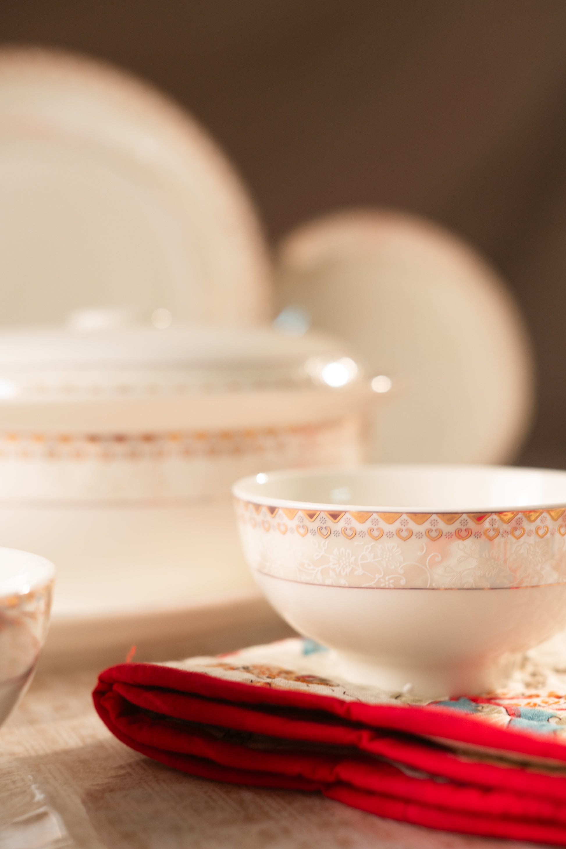 Ceramic bowls with decorative patterns on a tablecloth.