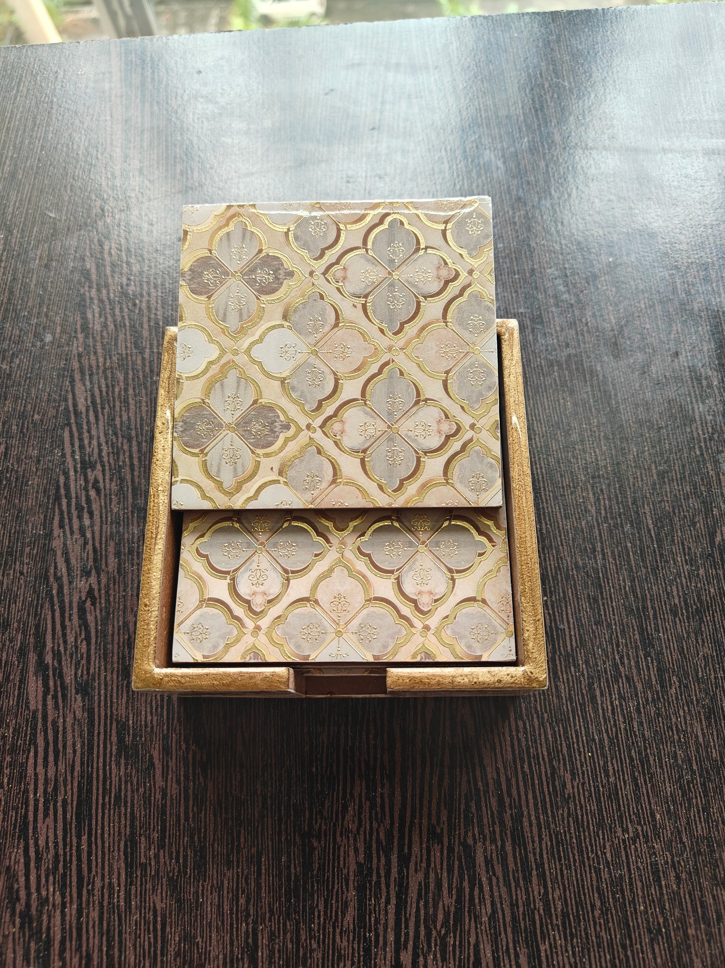 Decorative Wooden Coasters with intricate patterns on a dark surface